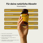 Reeleef Immune Boost Glas mit Kapseln vor dem Glass. Neem Pulver in Neem Kapseln zur Unterstützung des Immune Systems und der Abwehrkräfte