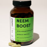 Reeleef Neem Boost - Neem Kapseln im Glas mit Neem Kapseln vor dem Glas. Neem Pulver in Neem Kapseln für ein natürliches Detox, Magendarmgesundheut und innere ballance